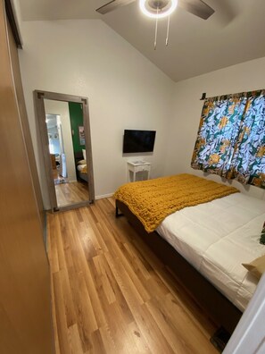 Relax in this inviting bedroom with a comfortable bed, television, and ceiling fan.