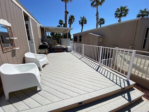 Relax on the covered deck with comfortable seating and a shaded area.
