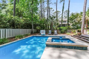 Relax by the pool surrounded by lush greenery and enjoy a game of basketball.