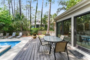 Enjoy dining or socializing on the deck with a round table and comfortable chairs.