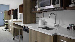 A modern kitchen with a microwave, sink, and cabinets. - Home2 Suites by Hilton Baton Rouge Citiplace (Baton Rouge)