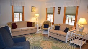 A living room with two sofas, a chair, a glass coffee table, and two lamps. - Aramabad- Close to Beach. Shared Water Access. (Chincoteague)