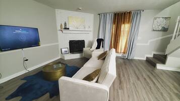 Smart TV, fireplace, books, computer monitors