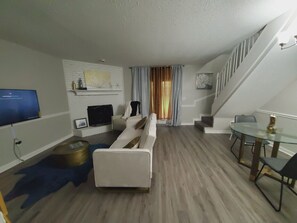 Smart TV, fireplace, books, computer monitors