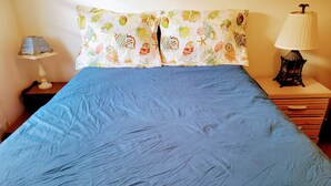 A bed with a blue bedspread and two pillows with a seashell pattern. - SunSplash,  WALK TO THE BEACH, WALK TO MAIN STREET (North Myrtle Beach)