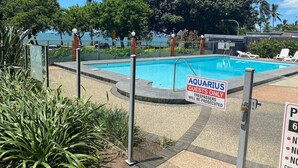 A swimming pool area with a sign indicating 'Aquarius Guests Only' and a warning that trespassers will be prosecuted. - It's all about the views! (Townsville City)