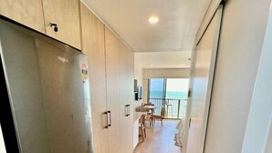 A modern kitchen with a large refrigerator, wooden cabinets, and a view to the outside. - It's all about the views! (Townsville City)