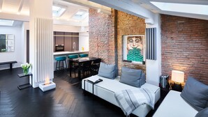 A modern interior with a dining area, kitchen, and seating space.