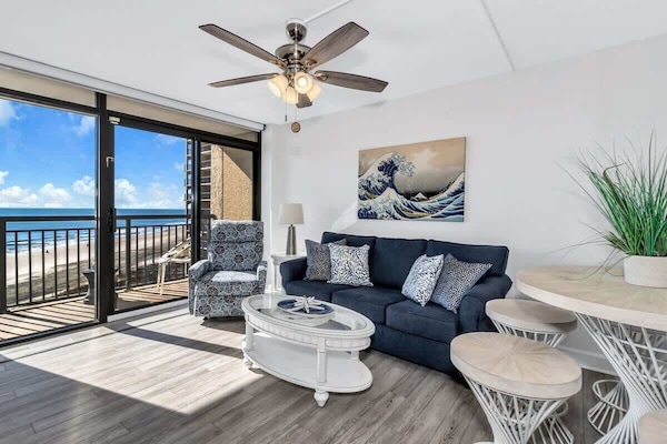 - Relax in a stylish living space with a comfy sofa and coastal-inspired decor - Floor to ceiling windows bring in endless ocean views and natural sunlight - Step onto your private balcony and take in the soothing sound of the waves