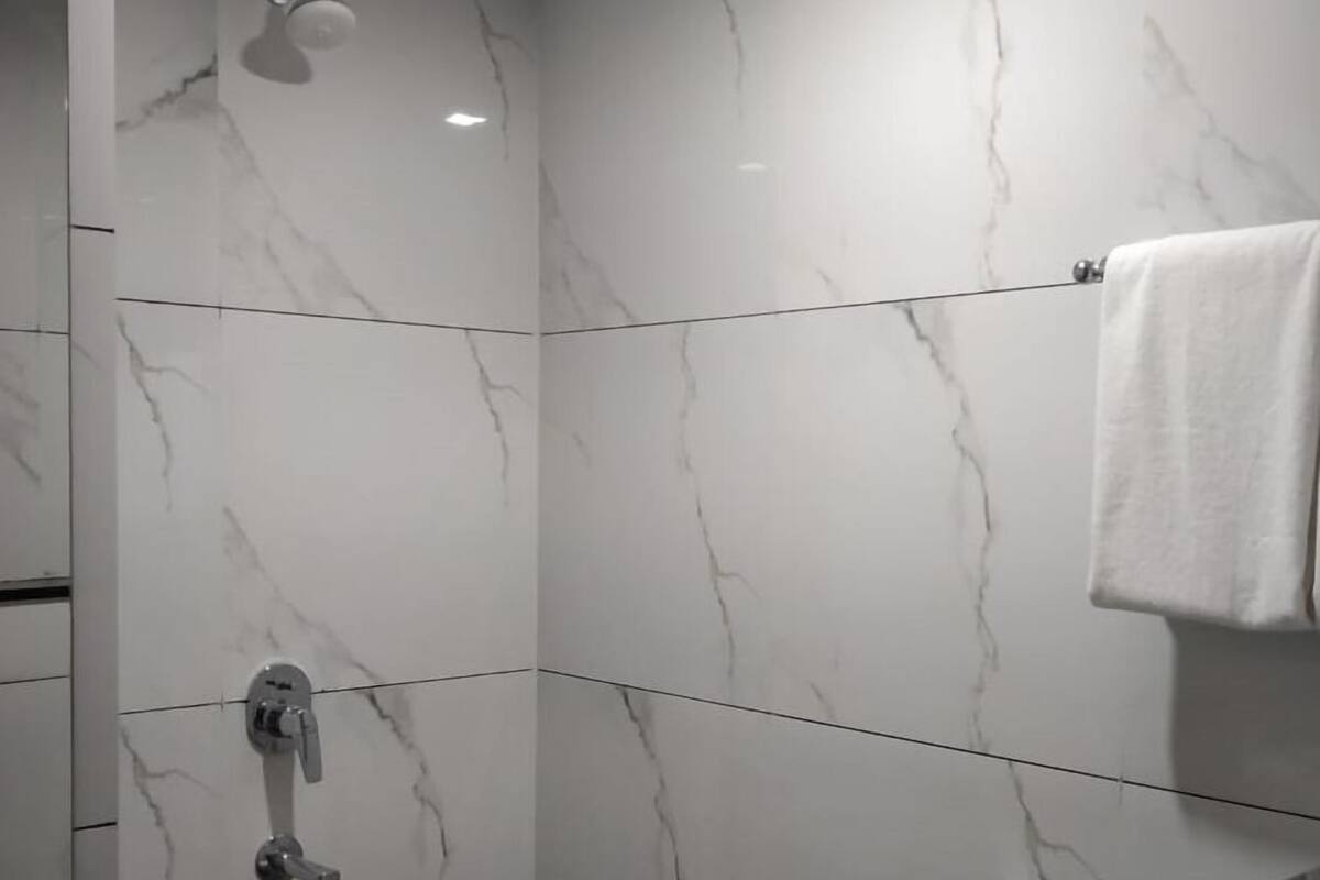 premium double room | bathroom | shower, rainfall showerhead, towels