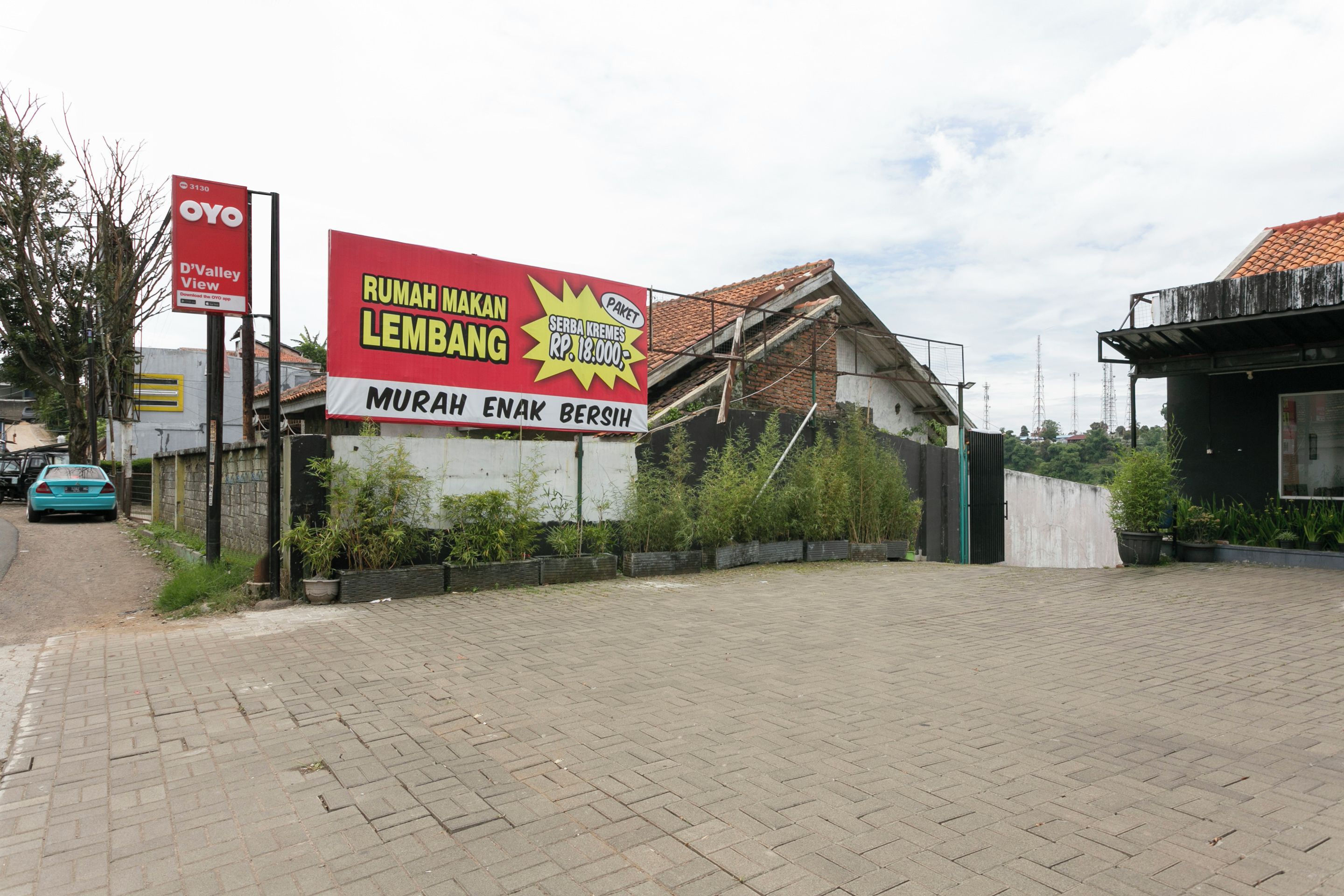 A paved area with a large billboard advertising a property sale.