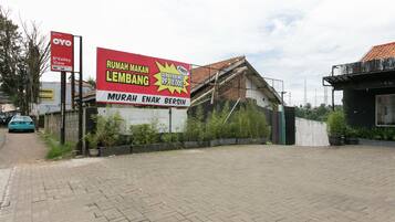 A paved area with a large billboard advertising a property sale.