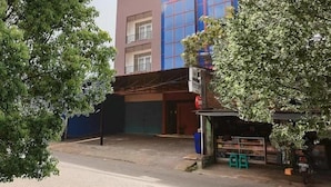 A multi-story building with a ground-level commercial space, a covered entrance, and a visible staircase leading to the upper floors. - OYO 3456 Citara Jaya Guesthouse (Bekasi)