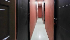 A corridor with doors on both sides, leading to rooms. - OYO 3456 Citara Jaya Guesthouse (Bekasi)