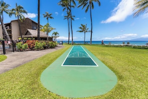 Enjoy shuffleboard on our ocean-view court, surrounded by palm trees and a modern hotel design.