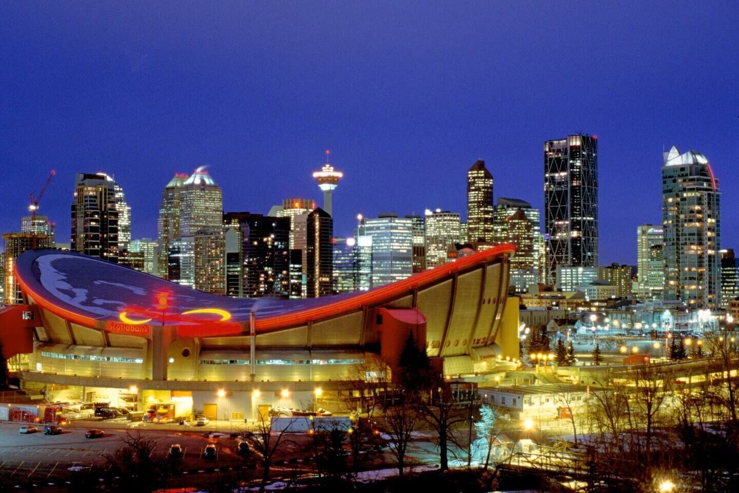 A modern building with a curved roof and a large, illuminated sign.