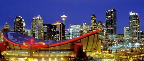 A modern building with a curved roof and a large, illuminated sign.