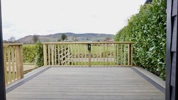 Step into a serene oasis surrounded by lush greenery and rolling hills.