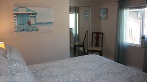 A bedroom with a bed, a chair, a ceiling fan, and a window with curtains. - Cozy 1 Bedrm/1 Bth, Walk to Downtown, Pet Friendly, Fenced yard, Covered Patio (Prescott)
