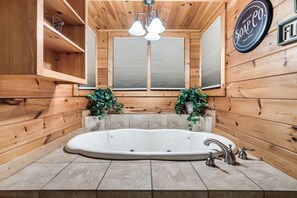 A wooden cabin bathroom with a freestanding bathtub, wooden shelves, and a sign that reads "Soap Co." - Spacious Family Cabin | 5 mi to National Park | Hot Tub | Arcade | Pool Access (Townsend)