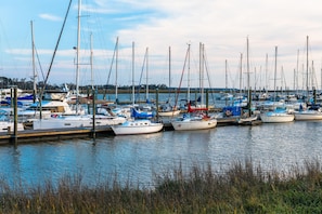Boats docked at the marina, surrounded by calm water and a scenic shoreline.