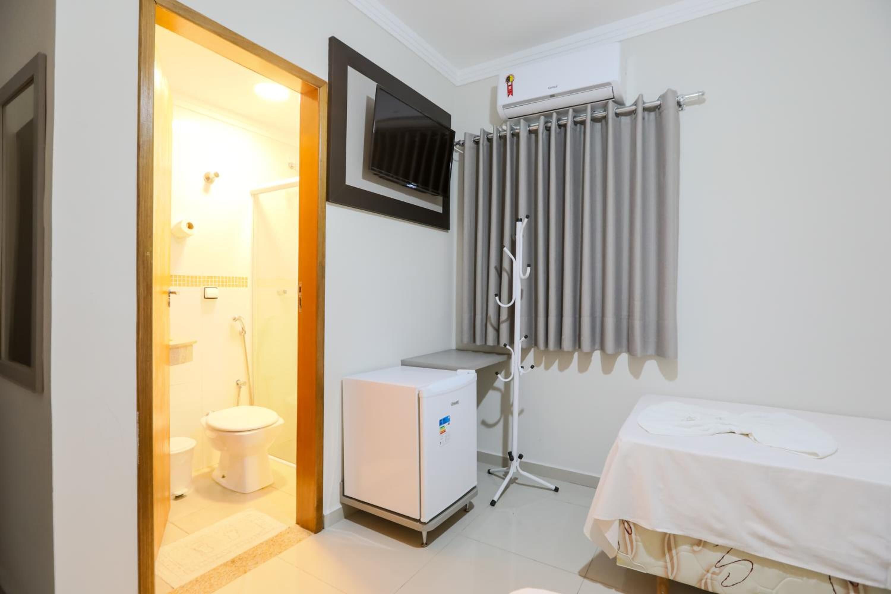 desk, laptop workspace, bed sheets