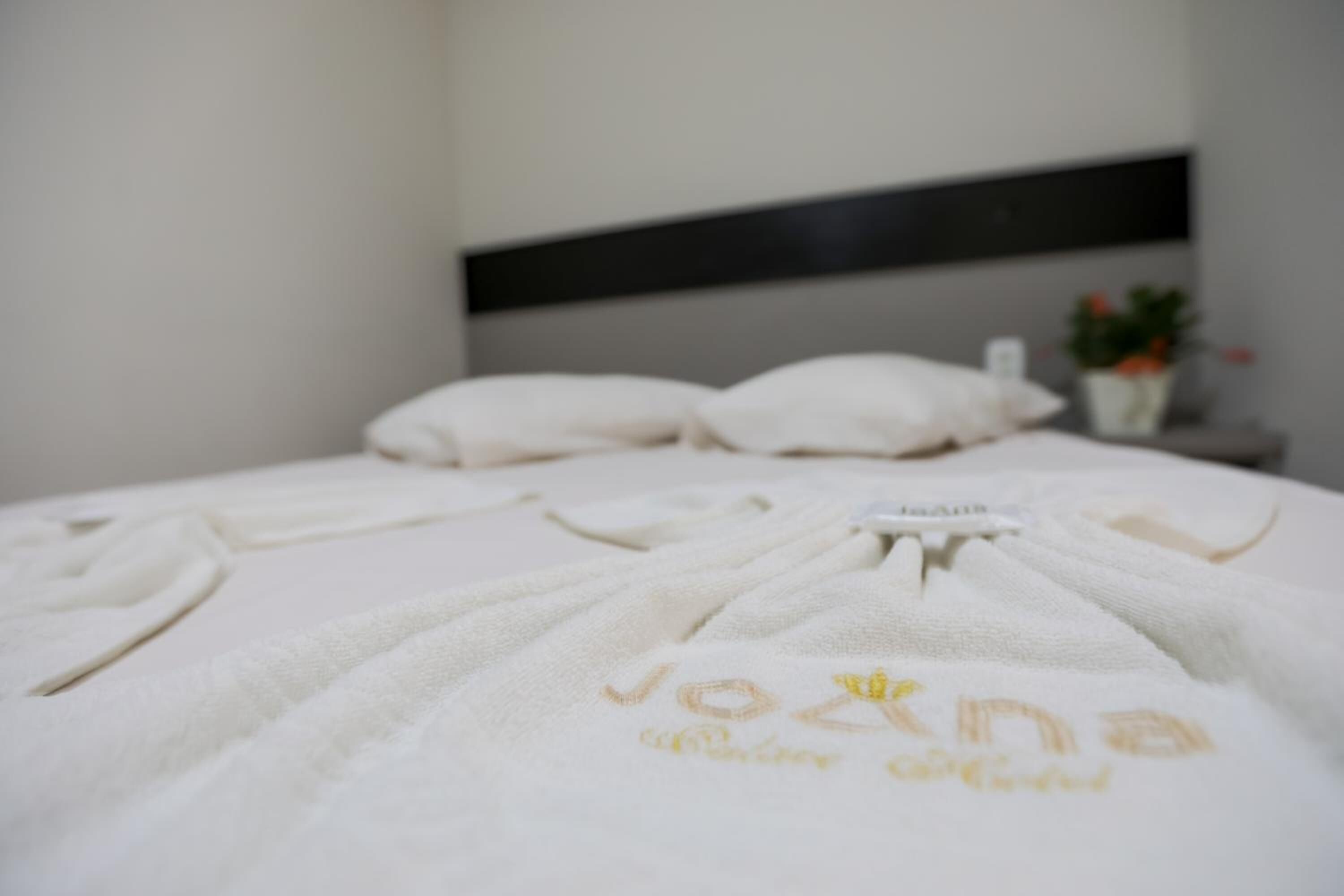 desk, laptop workspace, bed sheets