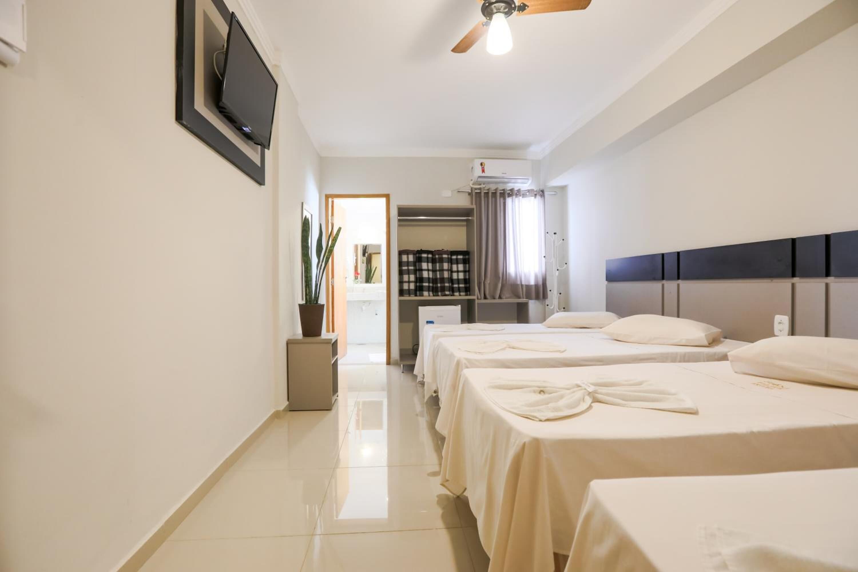 desk, laptop workspace, bed sheets