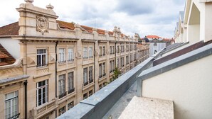 A row of historic buildings with uniform architecture, featuring ornate facades and uniform window designs.