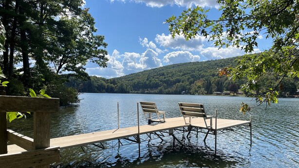 A wooden dock extending into a lake with two benches. - Garth Newell Waterfront -  Kayaks, canoes, water trampoline, fire pit, swimming (Maryland)