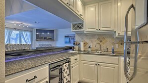 A modern kitchen with white cabinets, granite countertops, and stainless steel appliances. - Modern Townhome w/ Patio, Next Door to Resort (Horseshoe Bay)