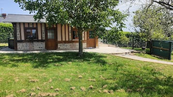 A building with a stone facade, wooden doors, and windows.