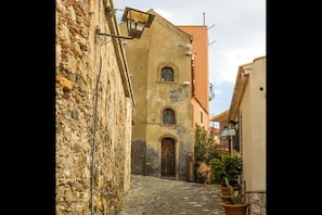 Stroll through historic streets lined with traditional doorways and potted plants.