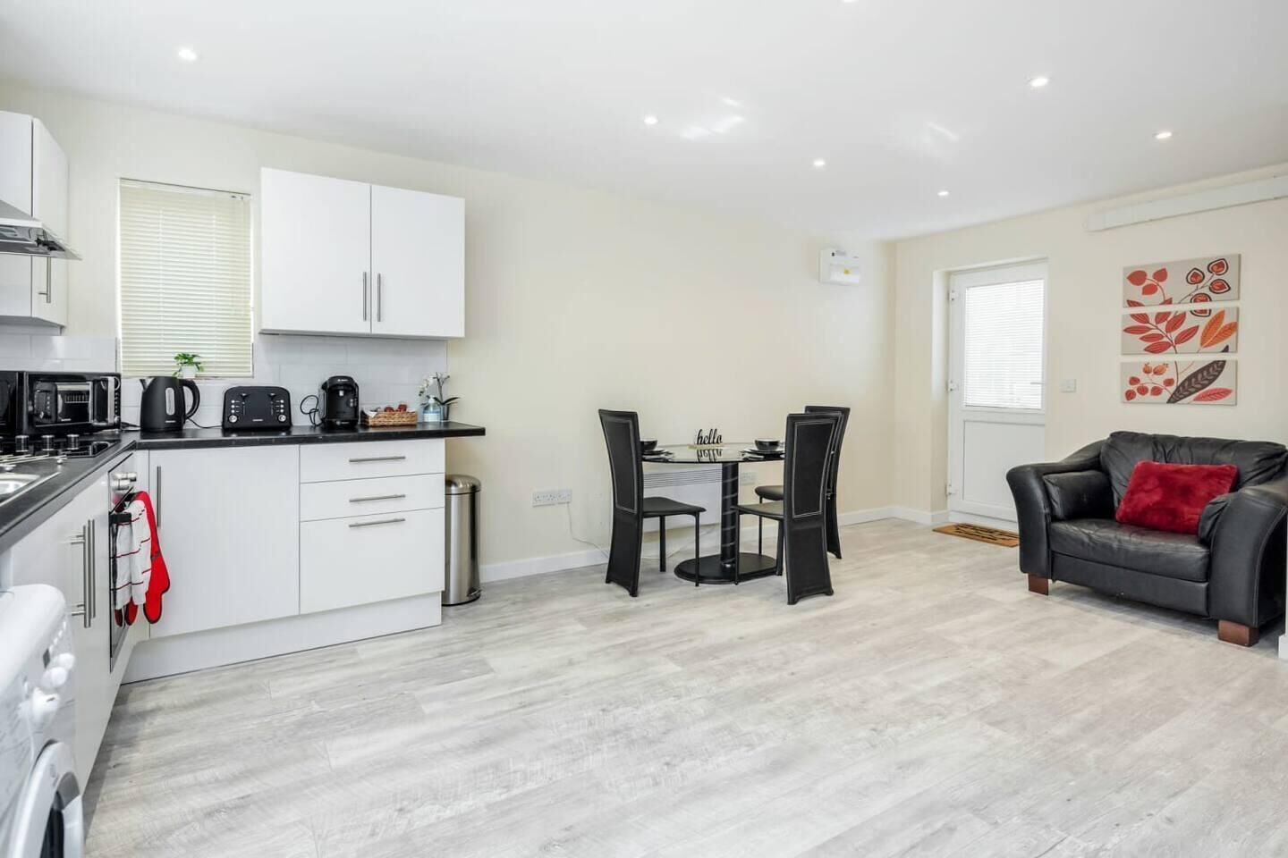 A compact living space with a kitchenette, dining area, and seating area.