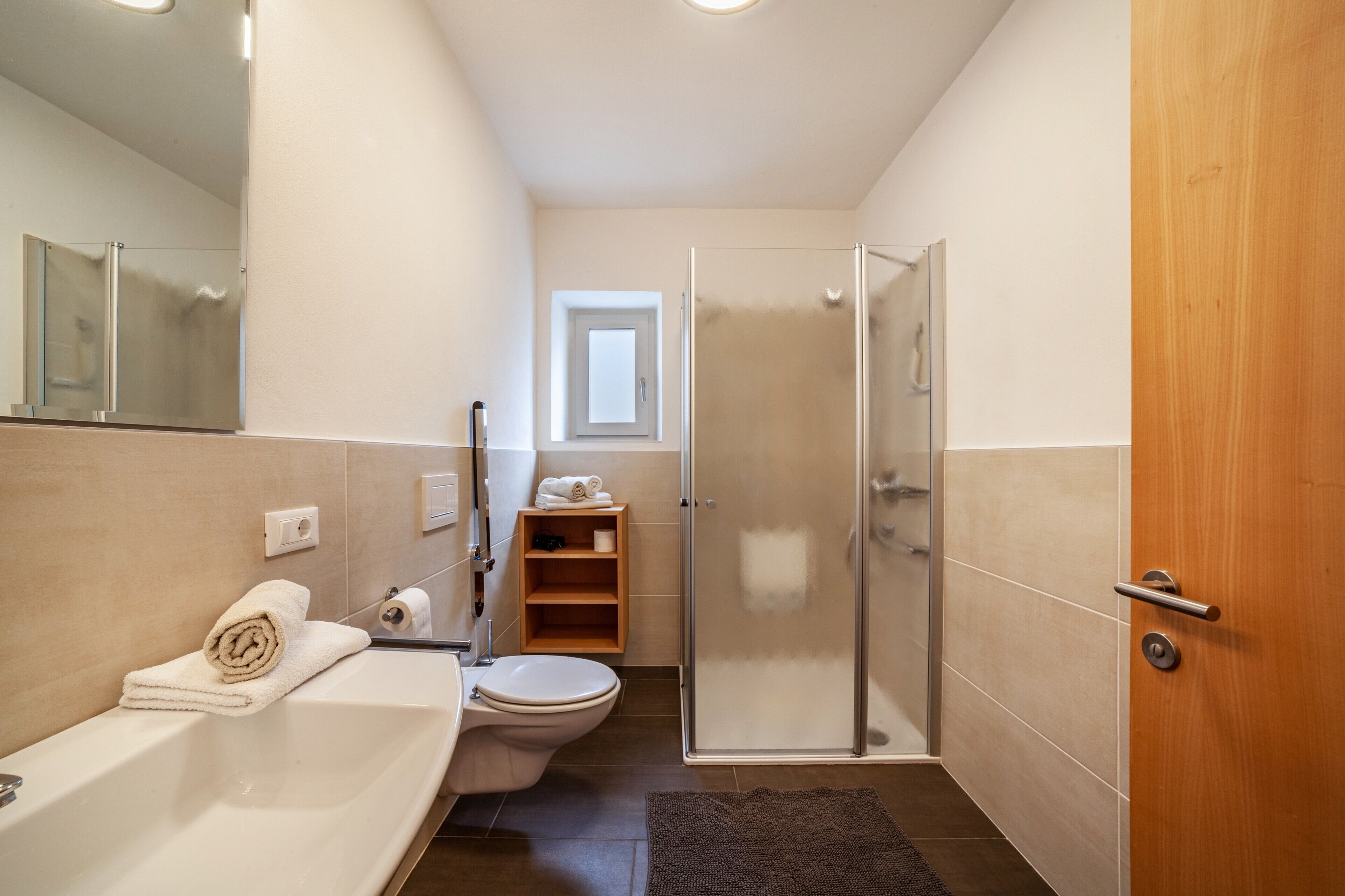 A bathroom with a bathtub, toilet, and shower.