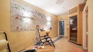 A hallway with a traditional mural, a wooden bench, a chair, and a sauna door.