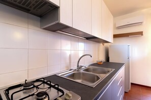Een koelkast, een oven, een kookplaat, een koffiezetapparaat/waterkoker