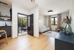 Deluxe Apartment, 1 Bedroom, Courtyard Area | In-room safe, desk, iron/ironing board, free WiFi