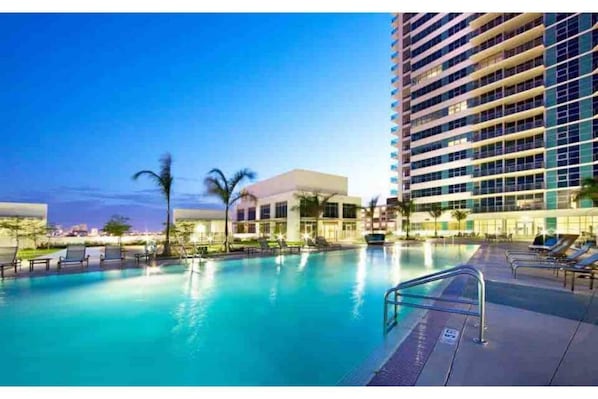 Relax by the pool, surrounded by comfortable lounge chairs.
