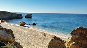 A beach with clear blue water, rocky formations, and a sandy shore. - Luxury Villa With Private Swimming Pool (Albufeira)