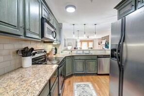 Dishwasher, coffee/tea maker, cookware/dishes/utensils, dining tables