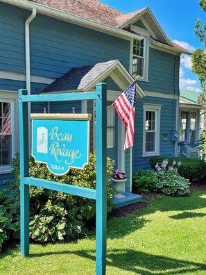 A house with a sign reading 'Beau Rivage 2824' and an American flag. - Beau Rivage Waterfront, kayak, SUP, great fishing, swimming, fire pit, updated (Portlandville)