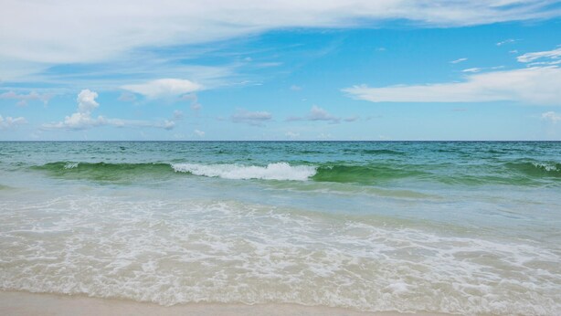 A beach with waves and a clear sky. - Walkable to Dining, Shopping, Beach | Sleeps 6 | Free Bike Rentals + More! (Santa Rosa Beach)