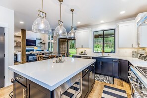 Enjoy cooking in this well-lit kitchen with a large island and stainless steel appliances.