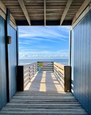 A wooden pier leading to a beach with a clear sky and ocean view. - Topsail Reef Breathtaking Paradise Vacay (North Topsail Beach)