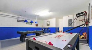 A pool table with a blue and white color scheme, a foosball table, and a basketball hoop. - 4 BR, Near Disney, Private Heated Pool/Spa, Game Room-Arcade, Free Resort Club  (Kissimmee)