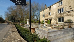 A building named 'The Wild Rabbit' with outdoor seating and a stone facade. - Old Stable Cottage, Kingham, Chipping Norton (Kingham)