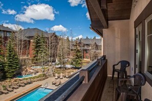 Enjoy the resort's tranquil atmosphere from this balcony overlooking the pool and lush surroundings.