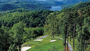A golf course with sand bunkers, a water body in the background, and dense forested hills. - Club Lodges at Trillium - 3 Bedroom Presidential (Cashiers)
