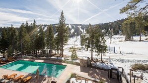 A pool area with lounge chairs and a view of a snowy mountain landscape. - Ritz Carlton Club, Lake Tahoe - 4 Bedroom (Truckee)